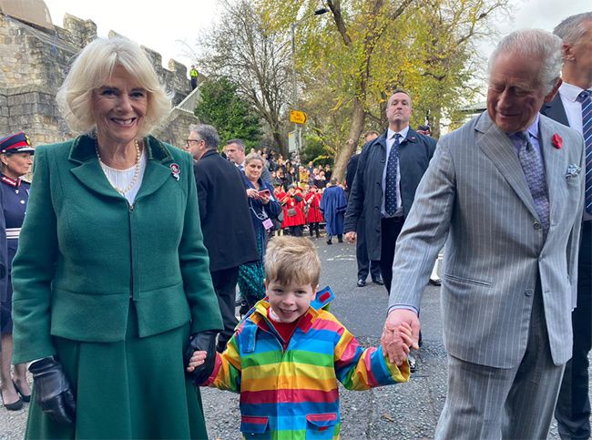 king charles camilla hold hands little boy