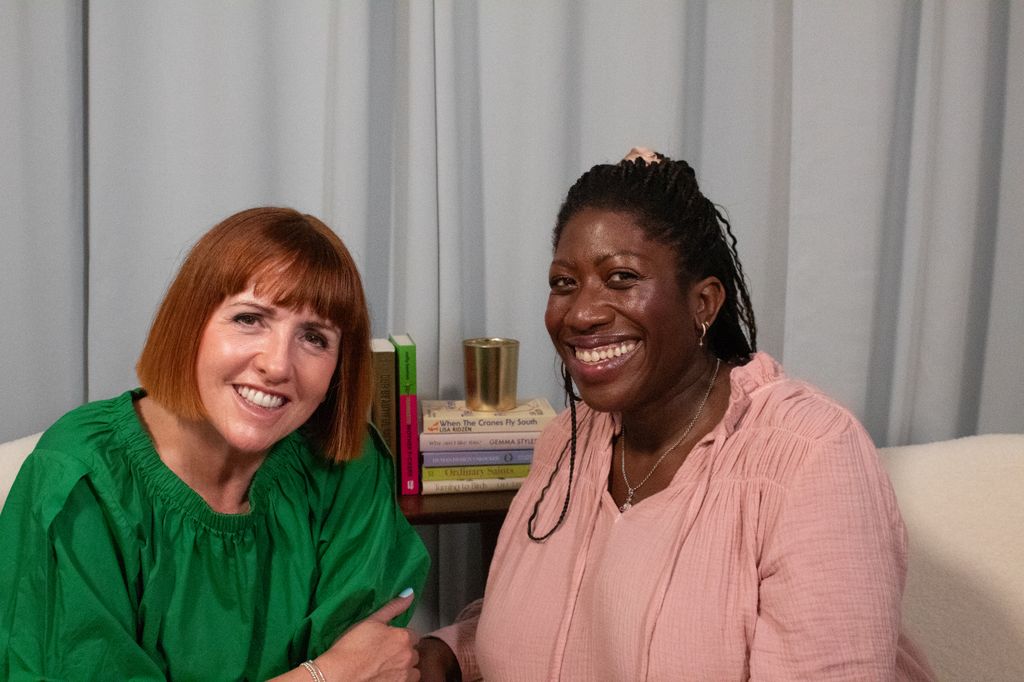 two women smiling in a podcast studio