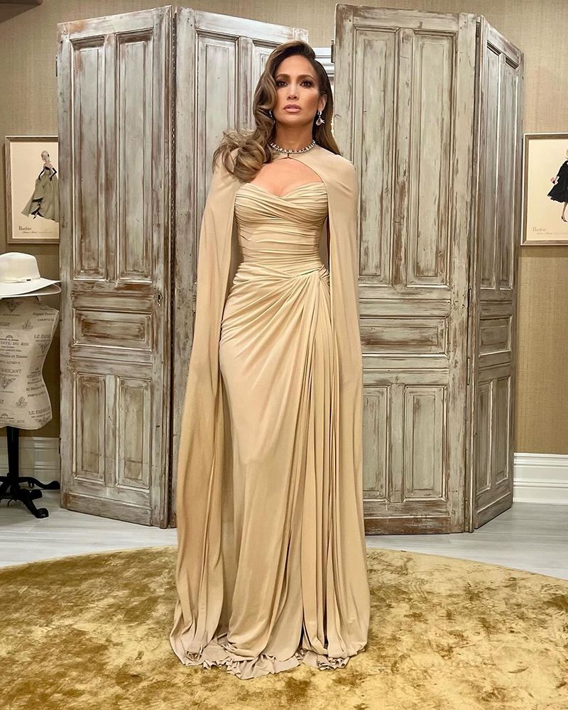 Jennifer Lopez wearing a gold caped gown