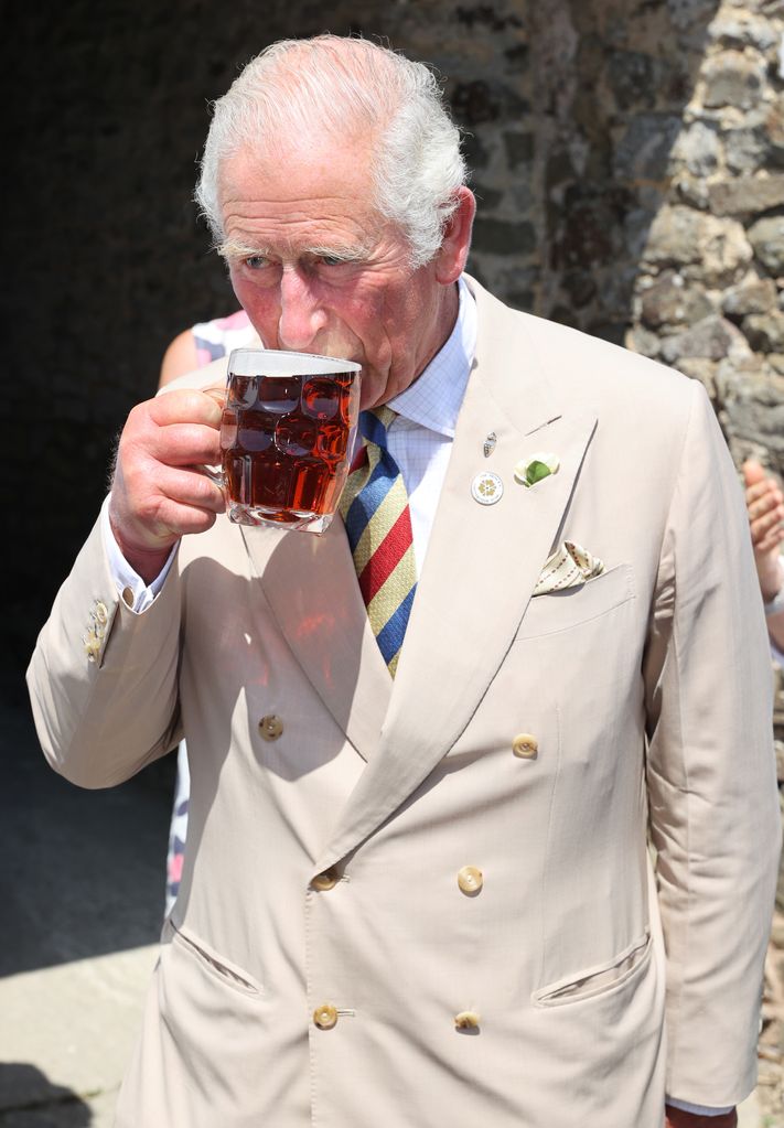king charles drinking a pint
