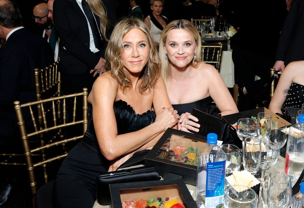 Jen and Reese sitting at table smiling