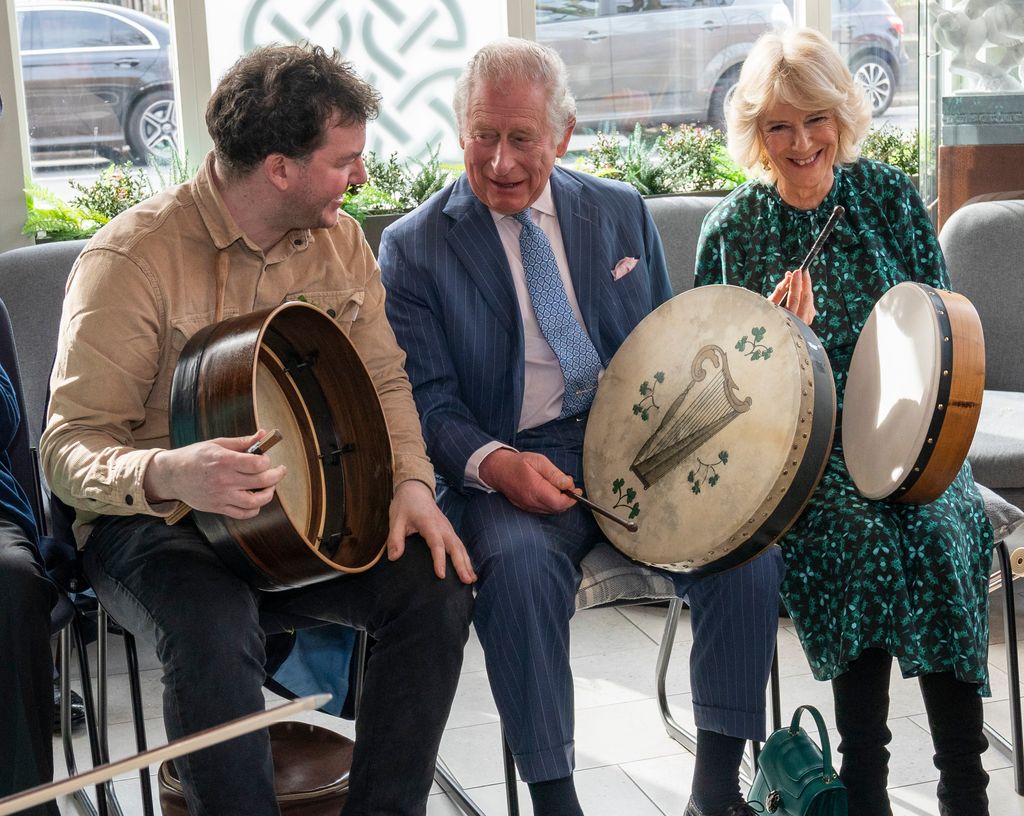 King Charles and Queen Consort Camilla playing drums