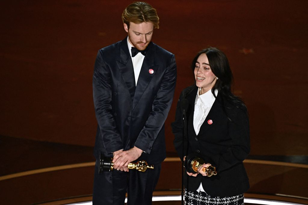 US singer-songwriter Billie Eilish (R) and US singer-songwriter Finneas O'Connell accept the award for Best Original Song 