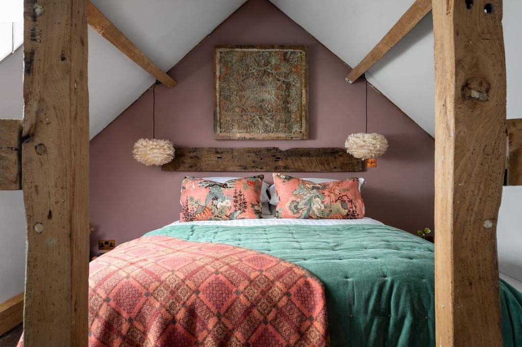 Elsie's Cottage bedroom with peach and mint soft furnishings and wooden beams
