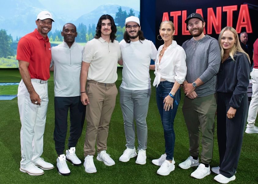 Celine Dion and her three sons pose with Tiger Woods and more at the TGL presented by SoFi match between the Atlanta Drive GC and the Jupiter Links Club at SoFi Center on March 4 in Palm Beach Gardens, Florida