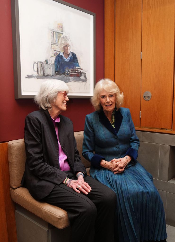 The Queen sits beneath her portrait, painted by artist Eileen Hogan (left) who has donated the artwork to Maggie's