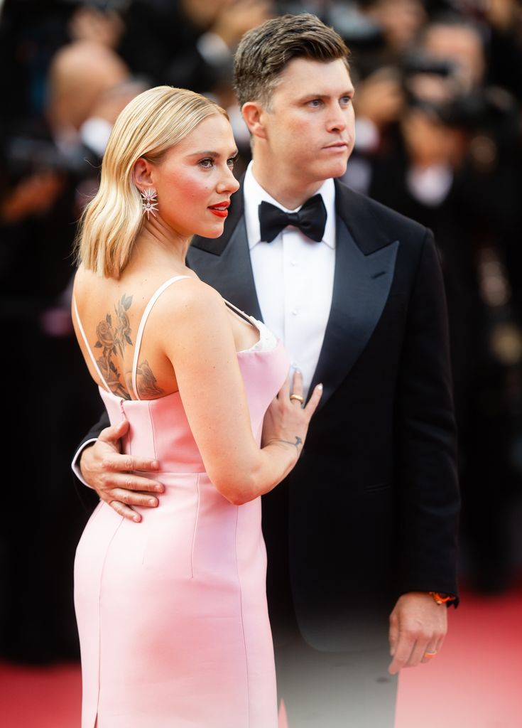Colin Jost and Scarlett Johansson attend the "Asteroid City" red carpet during the 76th annual Cannes film festival at Palais des Festivals on May 23, 2023 in Cannes, France.