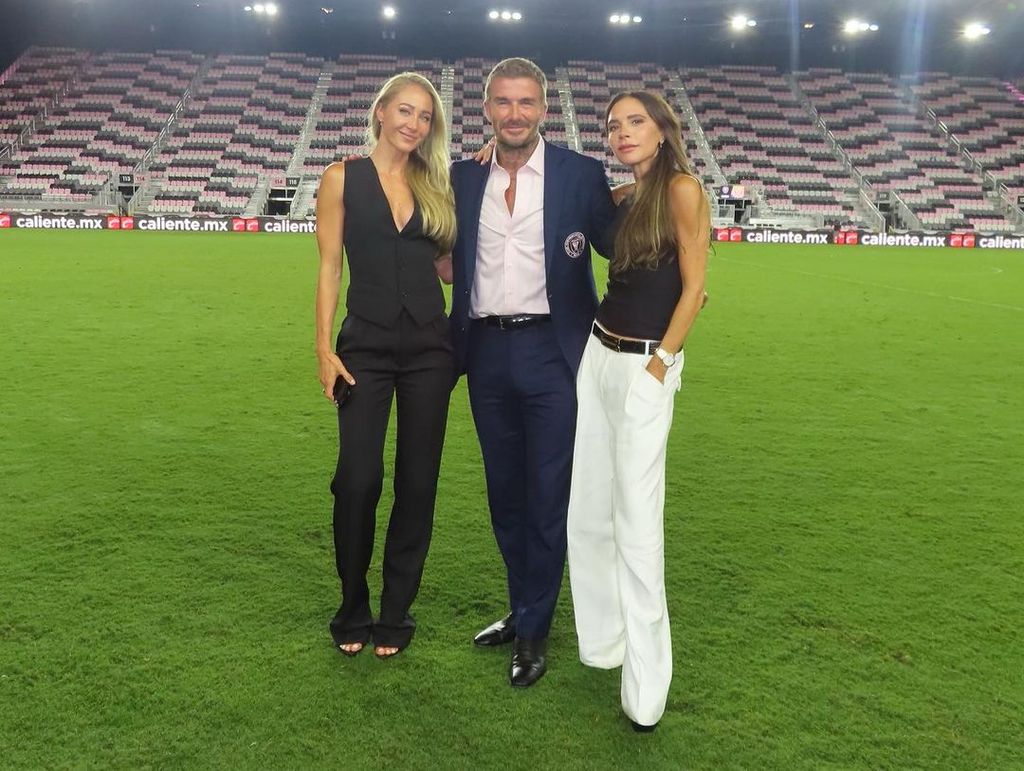 Victoria Beckham wears a monochrome ensemble beside her husband David Beckham in Miami