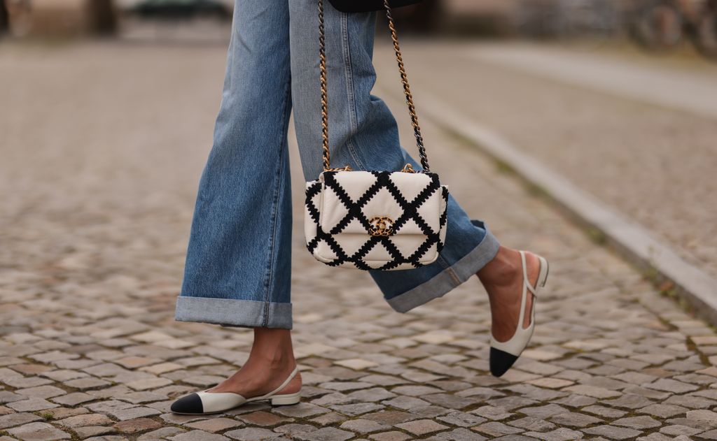 Jill Asemota wearing Chanel black and white bag