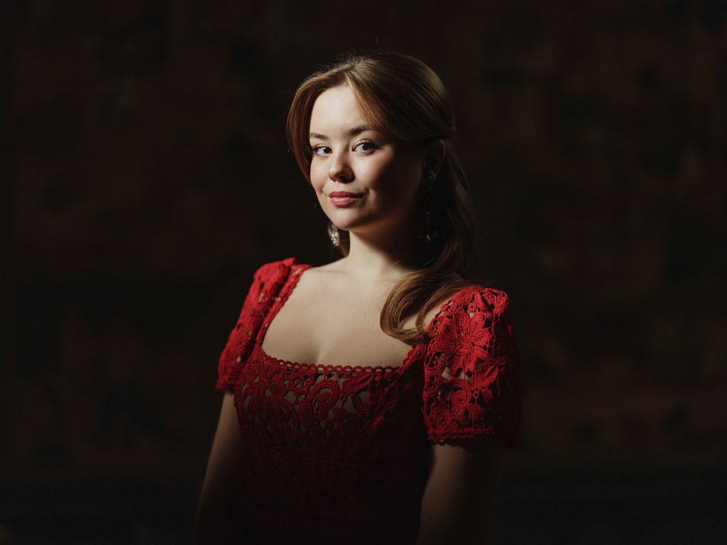 Princess Ariane posing in red lace dress