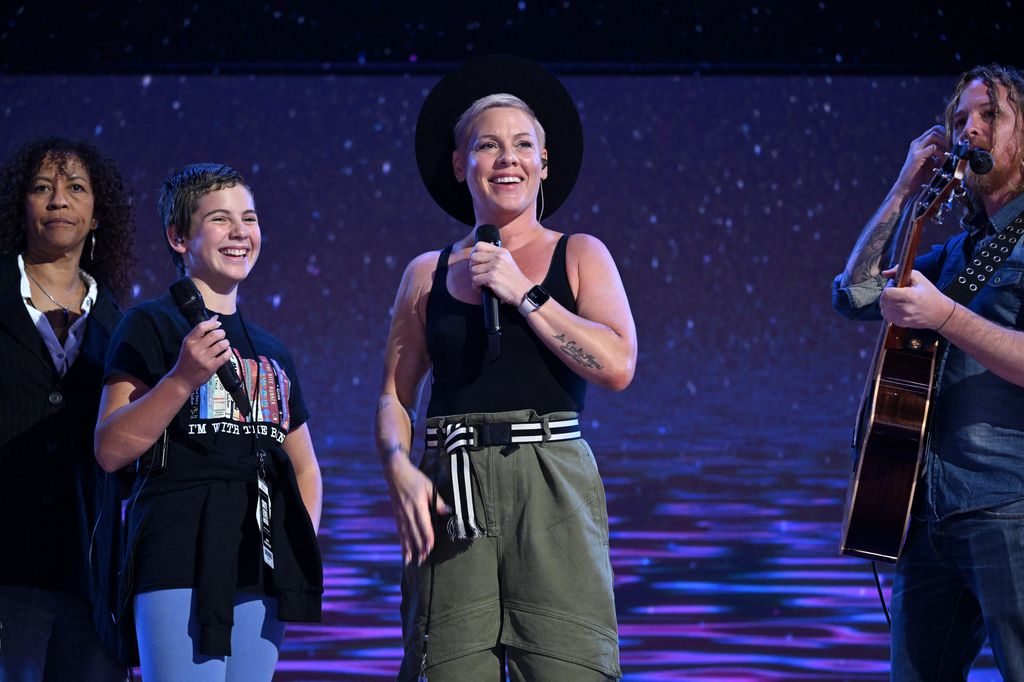 US singer Pink (C) and her daughter Willow (2nd L) sing What About Us