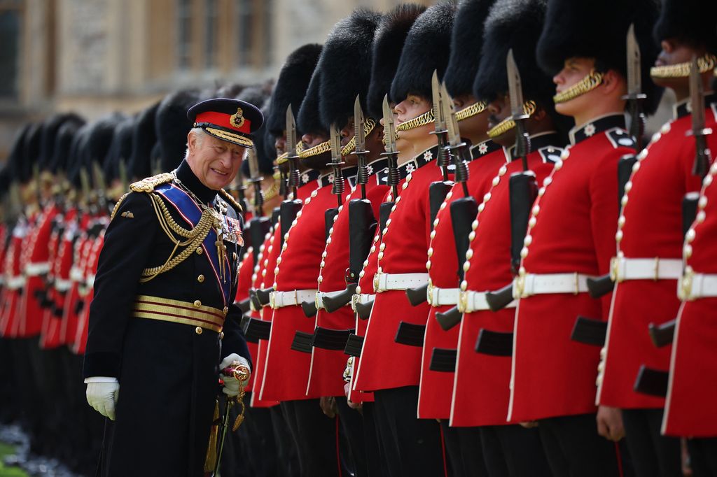King Charles III, Colonel in Chief of the Coldstream Guards inspects the regiment during a ceremony where he presents new Colours to the 1st and 2nd Battalion (Number 7 Company) the Coldstream Guards at Windsor Castle, west of London, on June 13, 2025. One of the new Colours will be carried by Number 7 Company in the Trooping of the Colour at The King's Birthday Parade in London on Saturday June 14, 2025. (Photo by HENRY NICHOLLS / POOL / AFP) (Photo by HENRY NICHOLLS/POOL/AFP via Getty Images)          