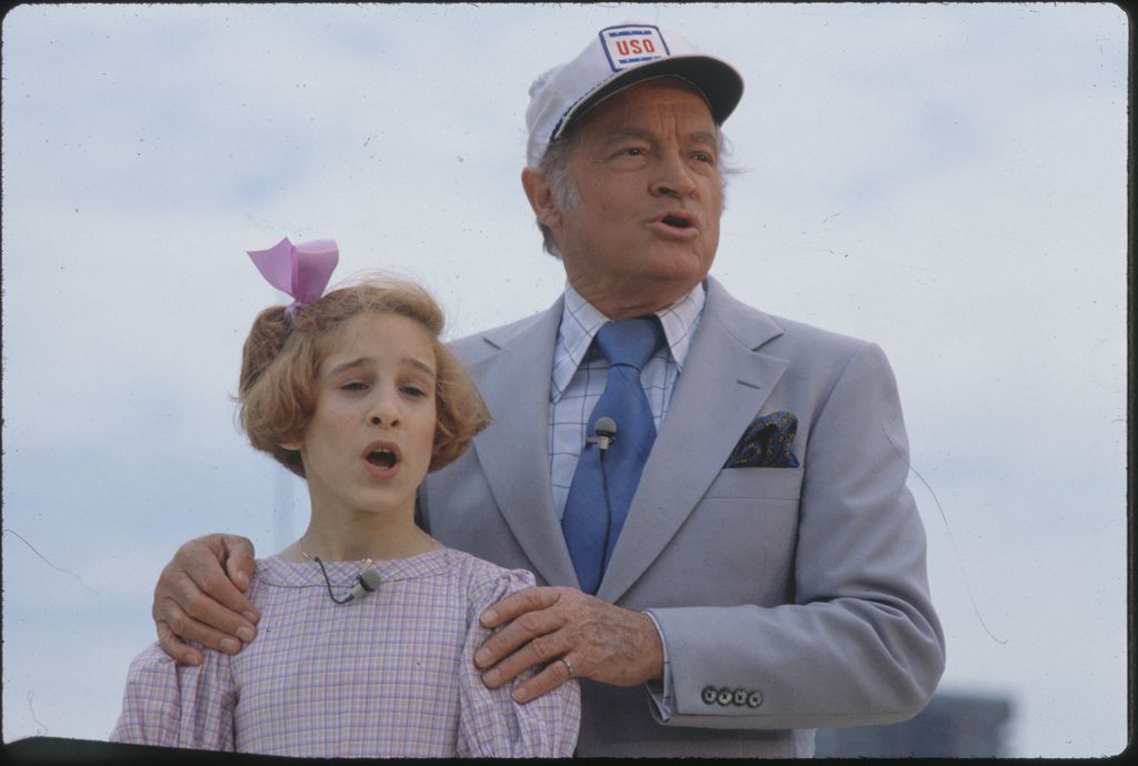 Bob Hope and Sarah Jessica Parker, as Annie, singing together at a USO show.