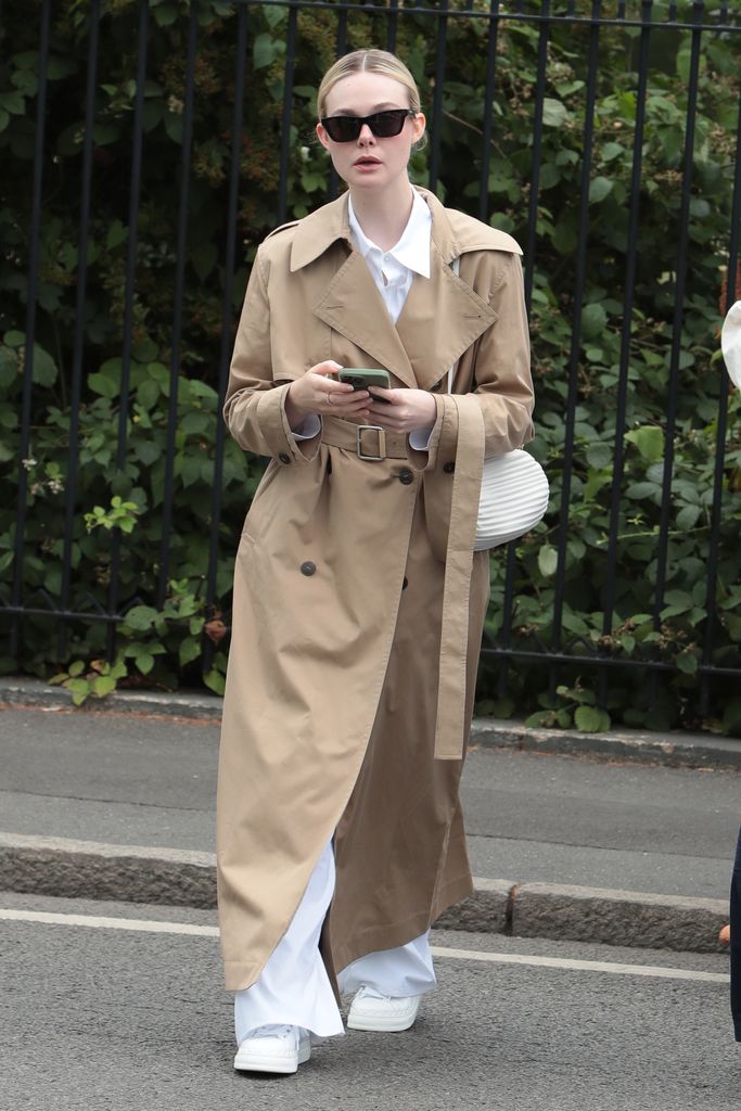 Elle Fanning wore all white on day two, with a beige trench coat layered on top