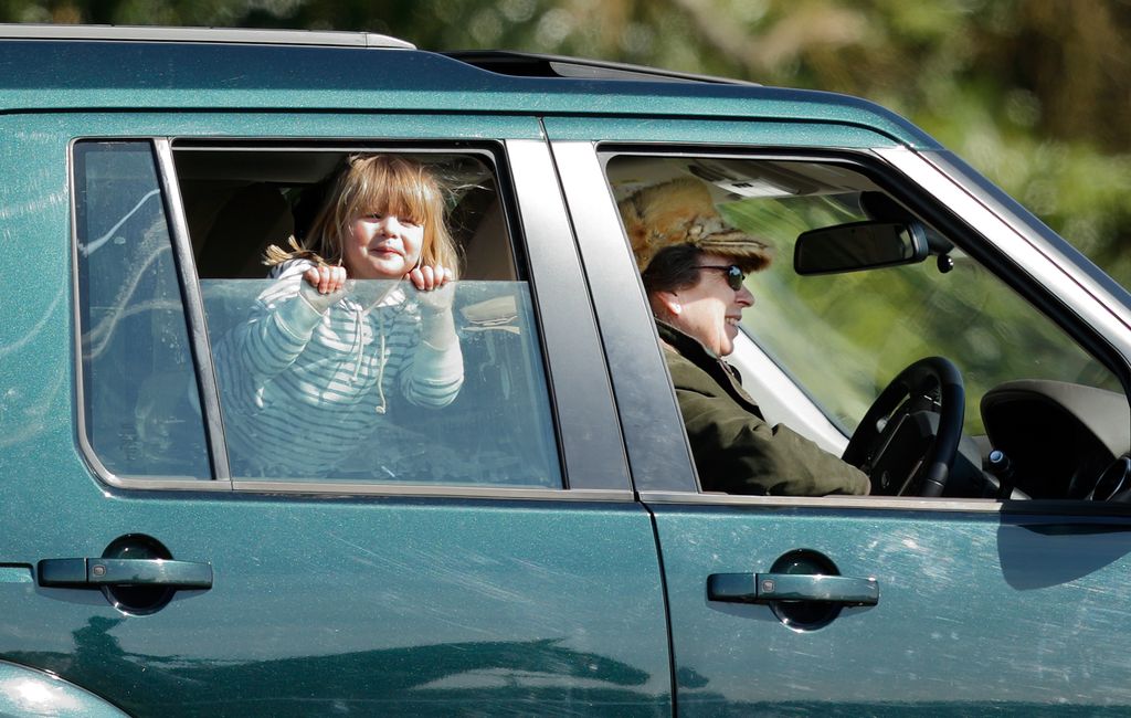 Mia peeks through the window of Princess Anne's car