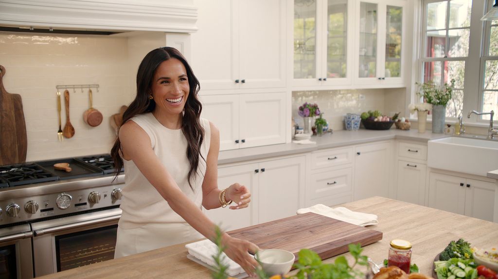 Brunette woman in kitchen smiling