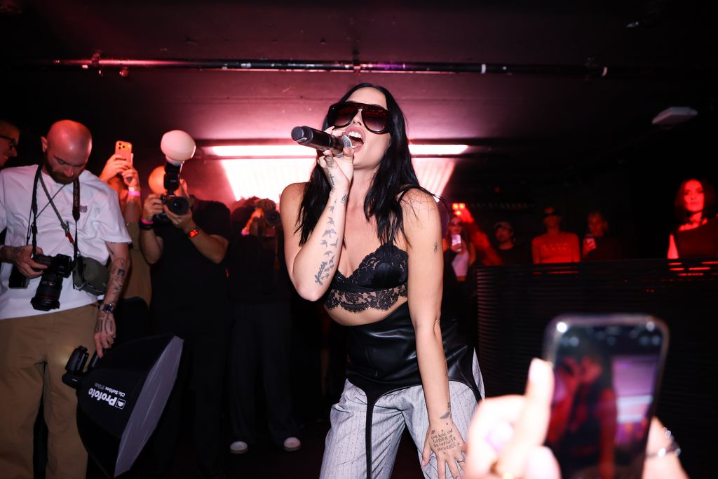 photo of demi lovato performing wearing sunglasses