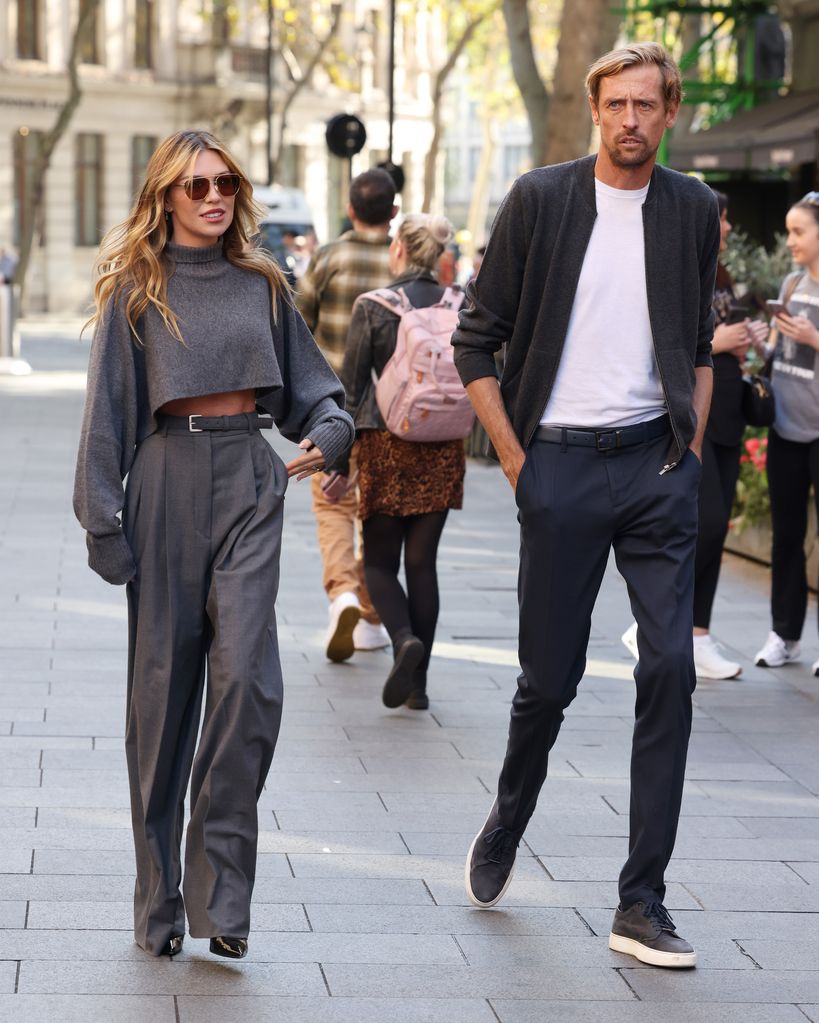 Abbey in an all-grey ensemble next to peter on street