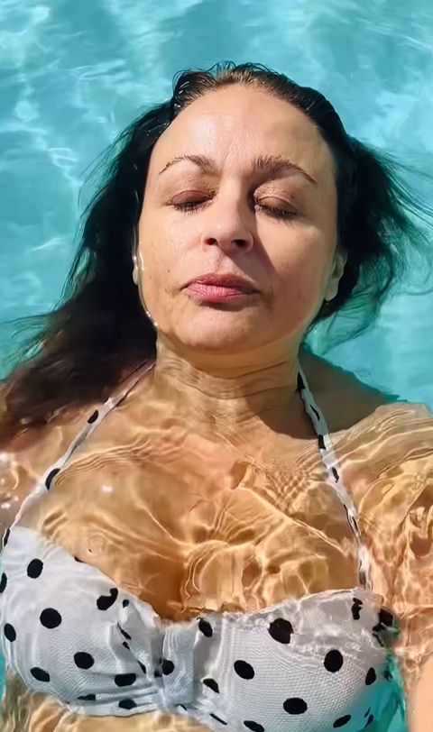 Nadia Sawalha in a bikini relaxing in a swimming pool