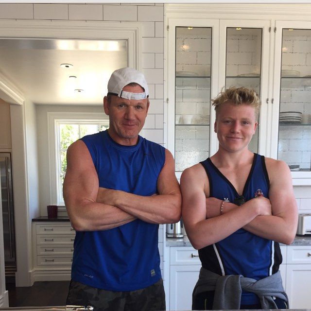 father and son posing in white kitchen