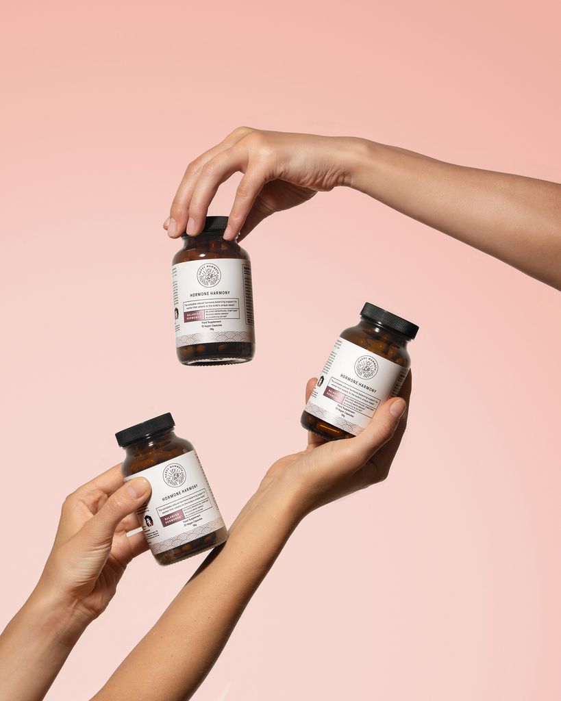 hands holding bottles of pills