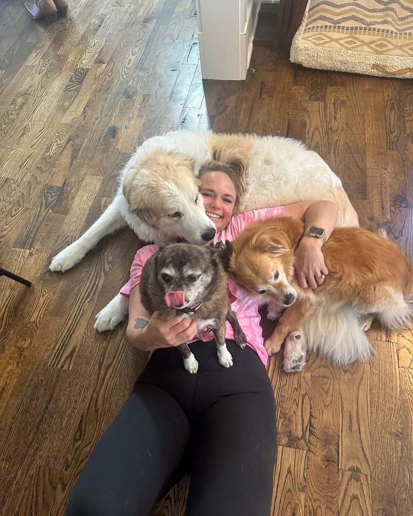 Miranda Lambert surrounded by three of her puppies