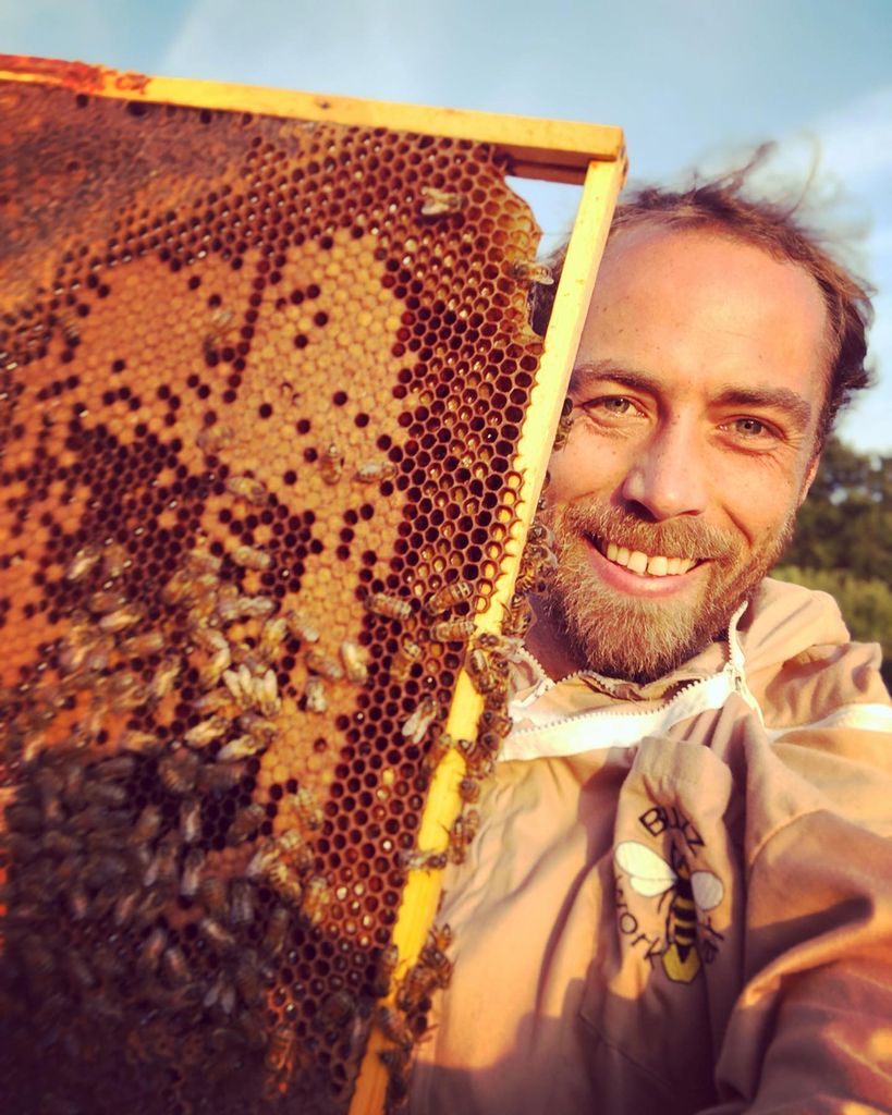 man holding beehive frame