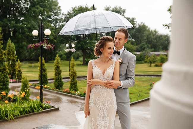 bride and groom wedding rain