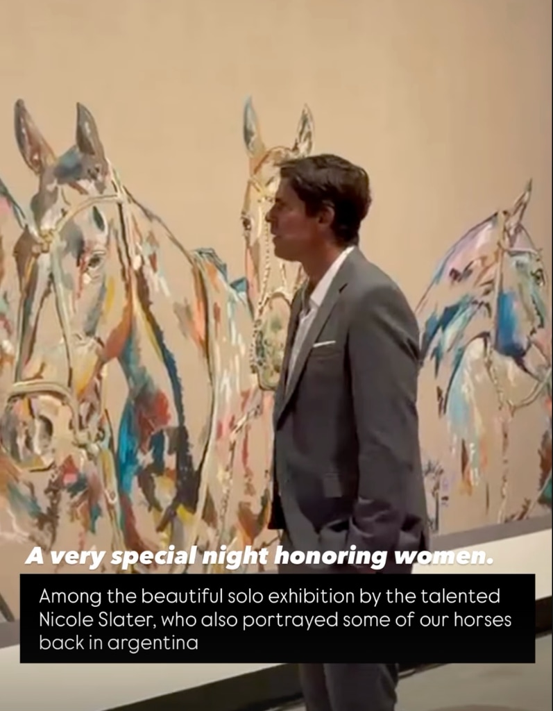 A photo of Nacho Figueras looking at paintings