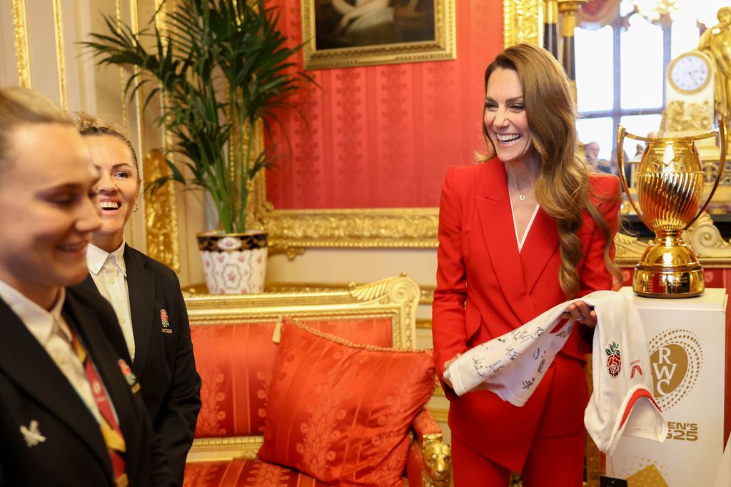 The Princess holds a signed shirt