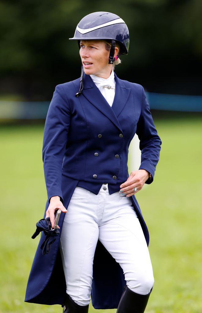 Zara Tindall holding gloves in her riding outfit