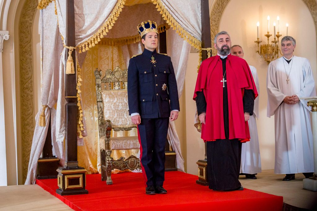 prince standing in front of throne