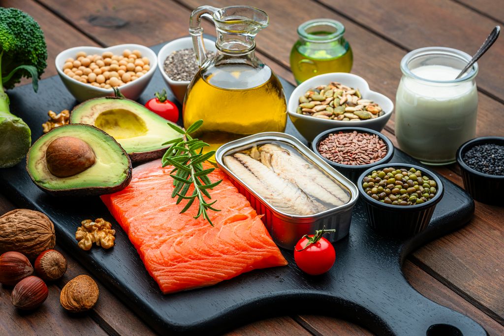 Group of healthy ingredients including olive oil, avocado, salmon, sardine, chia seed, nuts