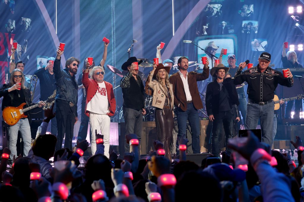 Ronnie Dunn, Sammy Hagar, Kix Brooks, Lainey Wilson, Riley Green, Lukas Nelson and Roger Clemens toast Toby Keith onstage during the 2024 CMT Music Awards