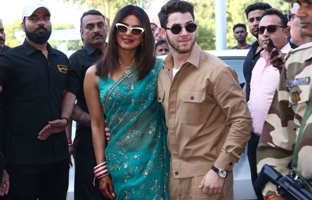 Priyanka Chopra in a green and gold dress with Nick Jonas