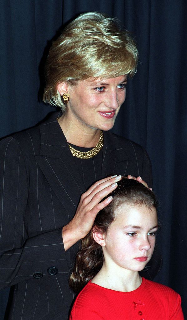  Diana,  Princess of Wales with Danielle Stephenson, a young child whose life was saved by pioneering surgeons, at Harrods book department where she was launching a new book in aid of research into heart and lung disease on October 15, 1996 in London, 