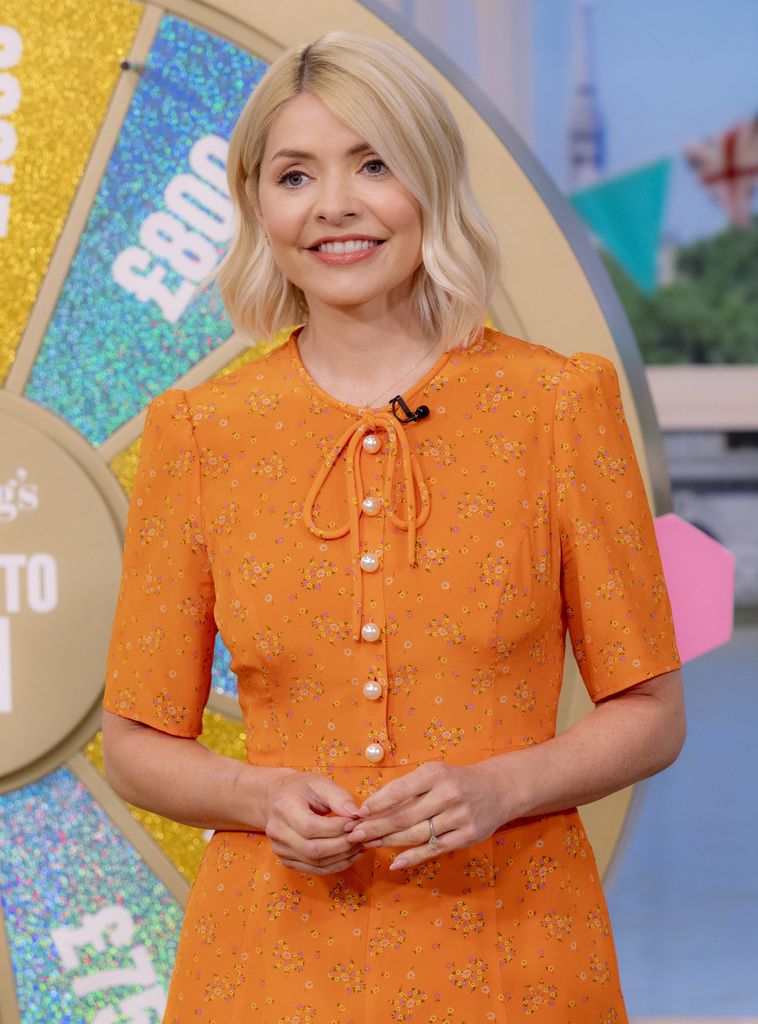 Holly Willoughby in an orange dress on This Morning
