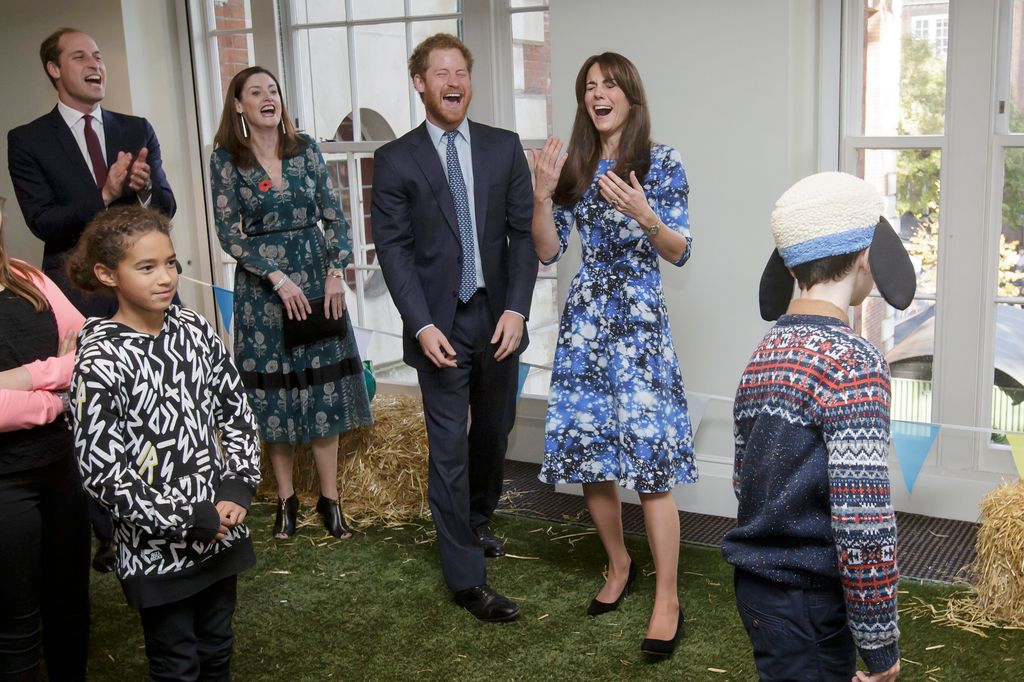 William, Kate and Harry laughing as they take part in welly wanging
