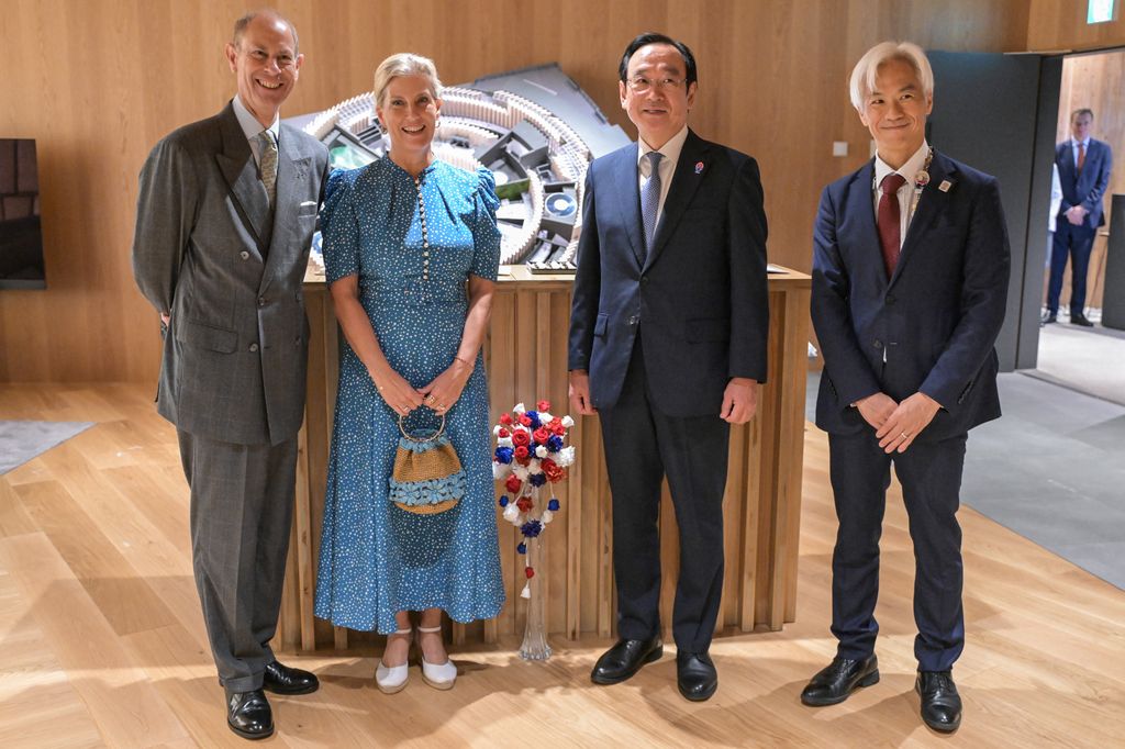 in a line Britain's Prince Edward (L), Duke of Edinburgh, and his wife Princess Sophie (2nd L), Duchess of Edinburgh, pose with pavilion director Noriyuki Kuroda (R) and Expo general commissioner Koji Hanada (2nd R) 