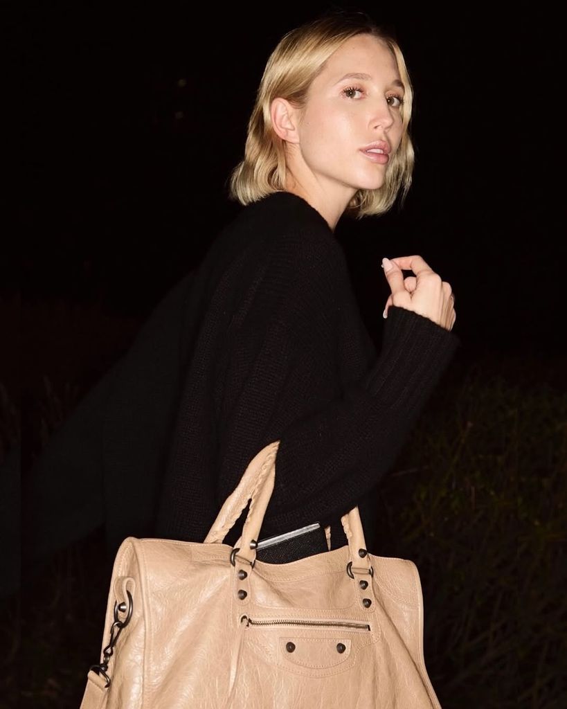 Olympia teamed her It-Girl accessory with a chic black jumper