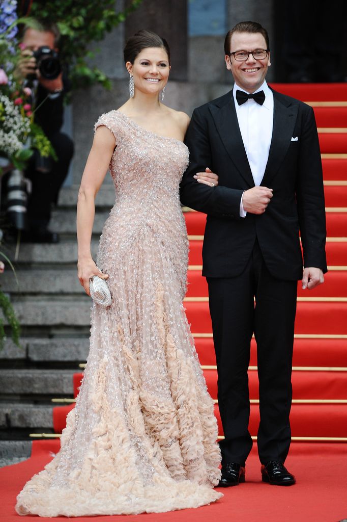 Crown Princess Victoria in a one-shouldered gown with Daniel Westling