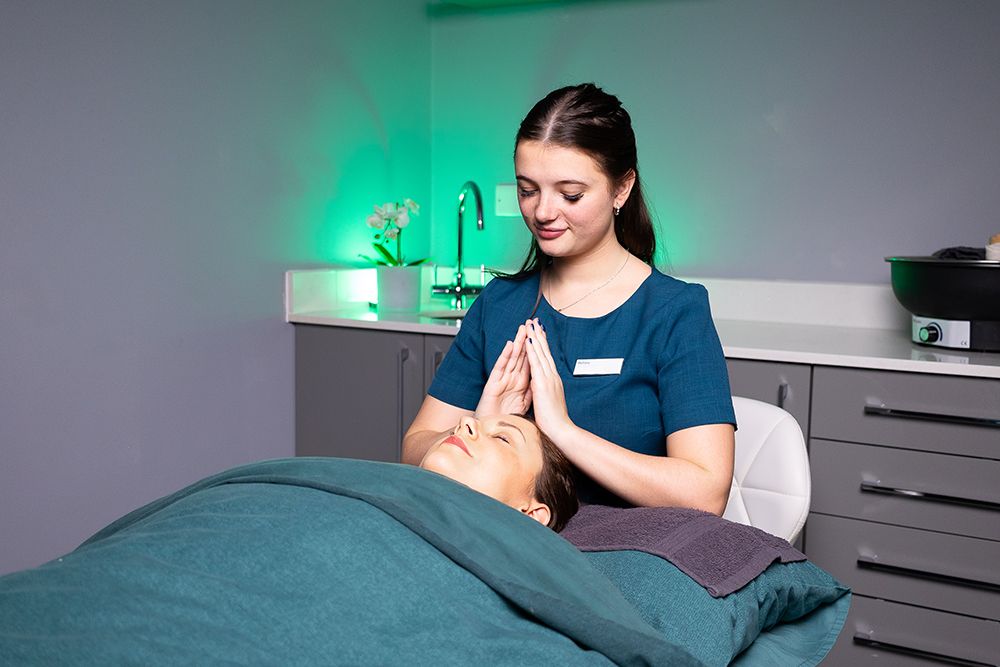 A therapist giving a facial at The Glass House Retreat