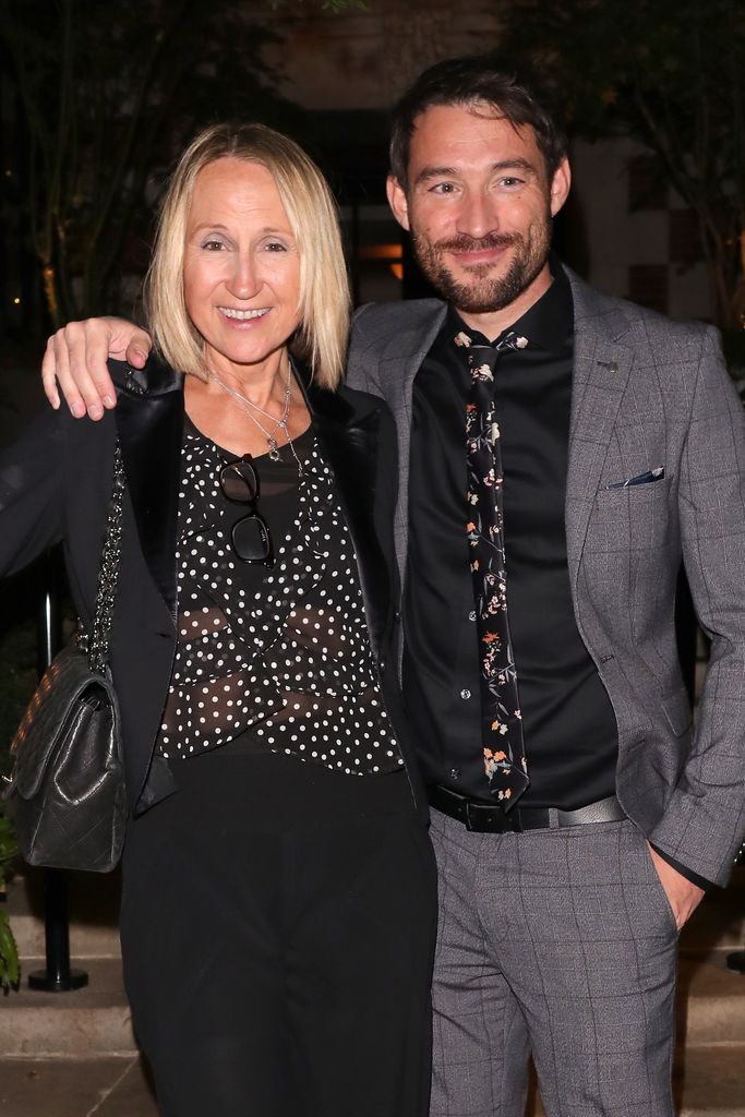 Carol McGiffin in a polka dot blouse smiling with her husband Mark Cassidy