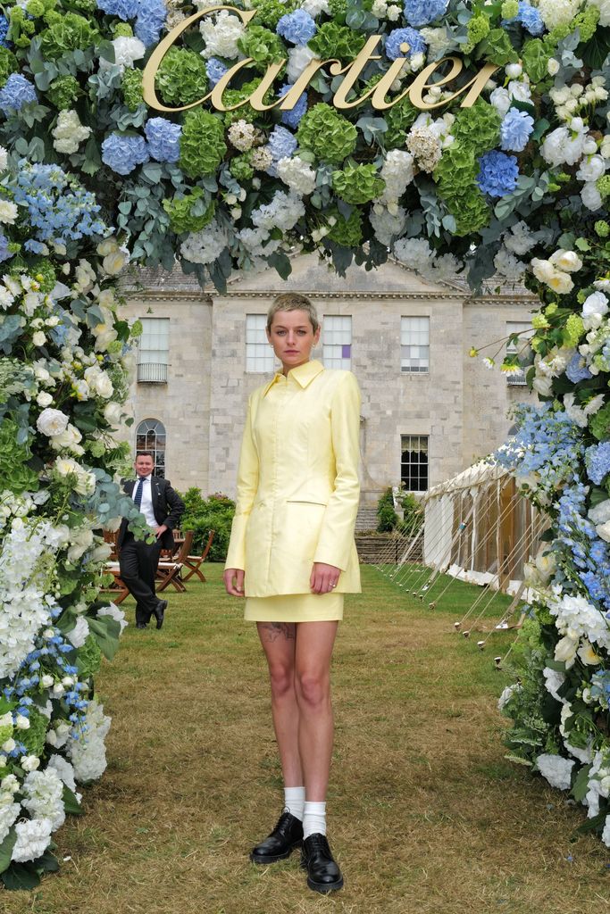 Emma Corrin wears a yellow suit and loafers at Goodwood Festival of Speed