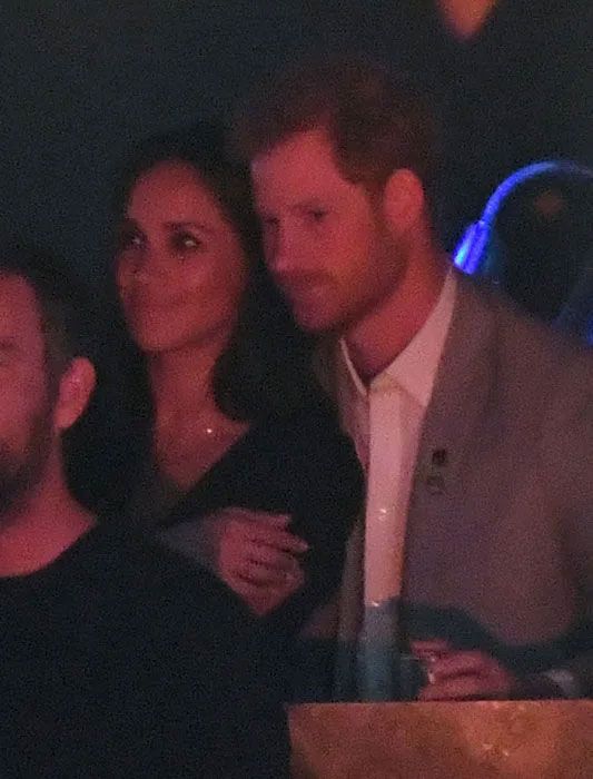 Harry puts his arms around Meghan at Invictus Games 2017