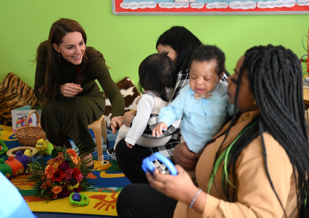 The Princess of Wales talks with parents and children during a Maternal Mental Health Alliance visit in 2022