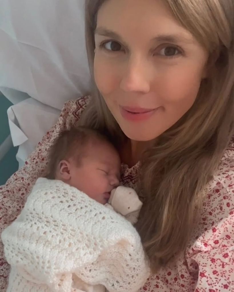 woman with newborn baby in blanket
