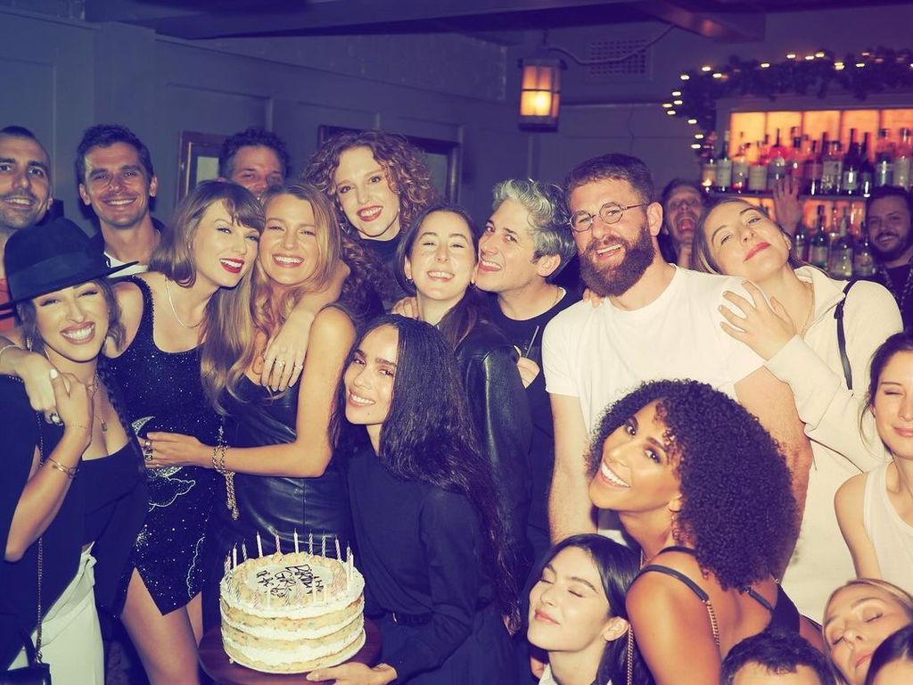 Taylor Swift is surrounded by friends and a birthday cake at Freemans