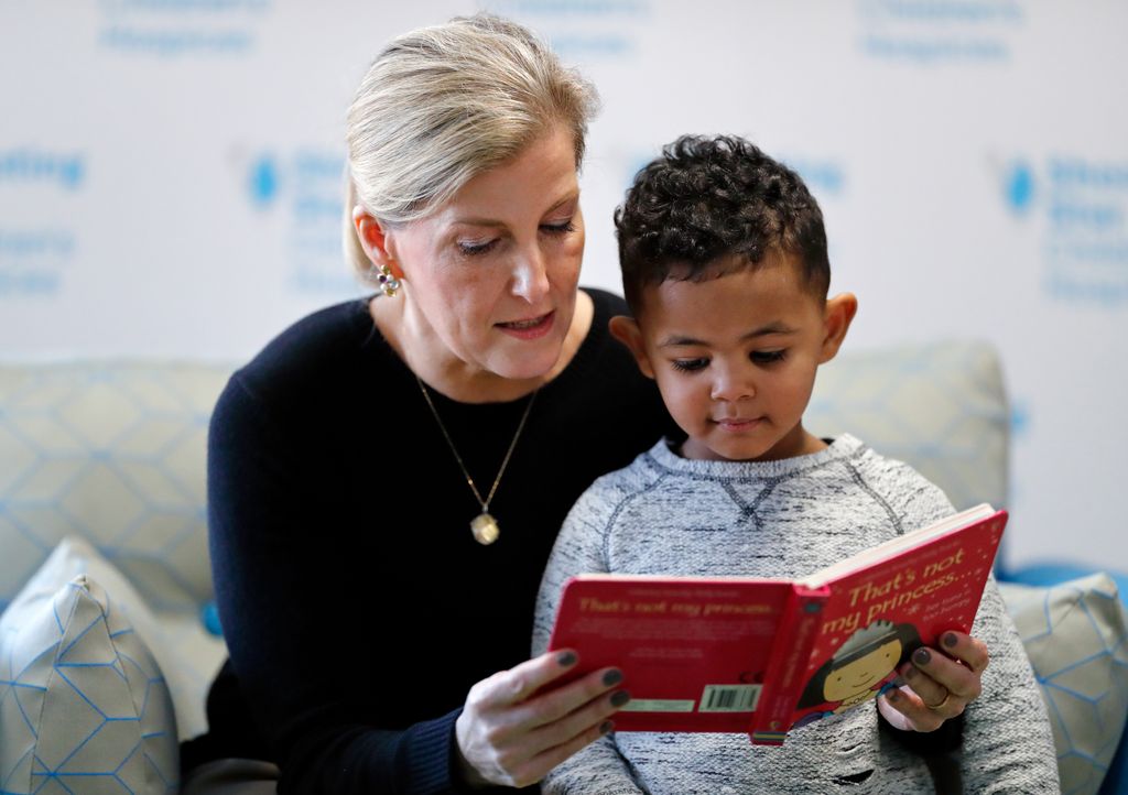 Sophie reads book to a little boy