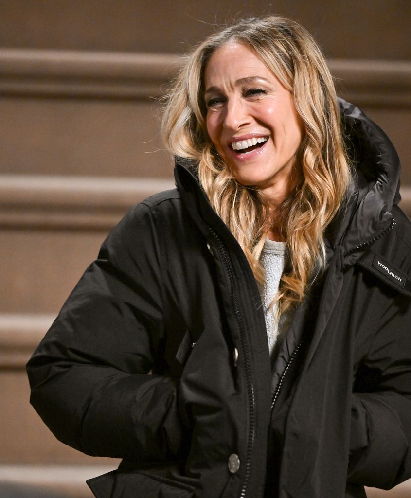 Sarah Jessica Parker smiling in a puffer jacket